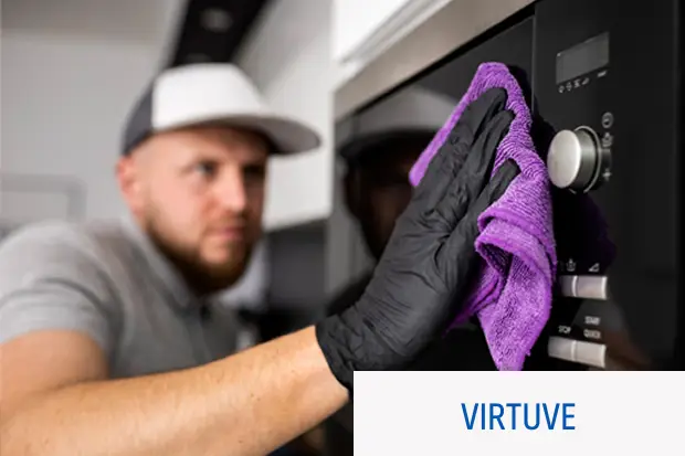 a man cleaning a microwave